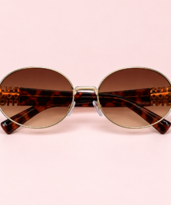 Lente de sol unisex LUMA ovalado con armazón dorado, cristales degradé marrón y patillas carey