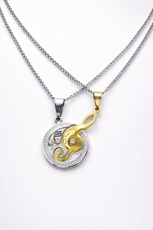 Dije redondo, combinado plateado dorado clave de sol