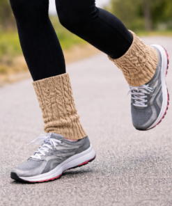 Piernas luciendo en movimiento Calentitas de lana con diseño trenzado tipo 8 en fondo neutro claro estilo catálogo color camel